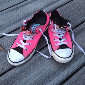 pink converse with multiple colorful tongues